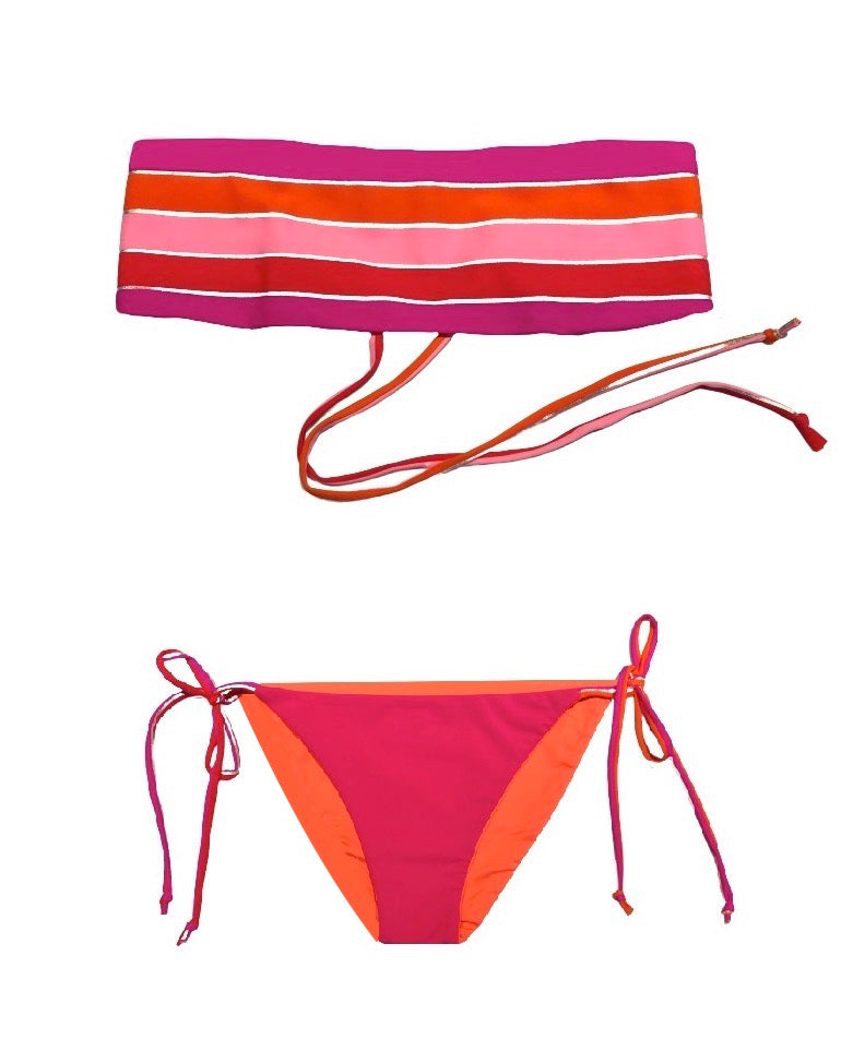 Bikini bandeau con estampado de rayas metalizadas plata en tono rojo, naranja, fucsia y rosa.  Braguita triangular fucsia.